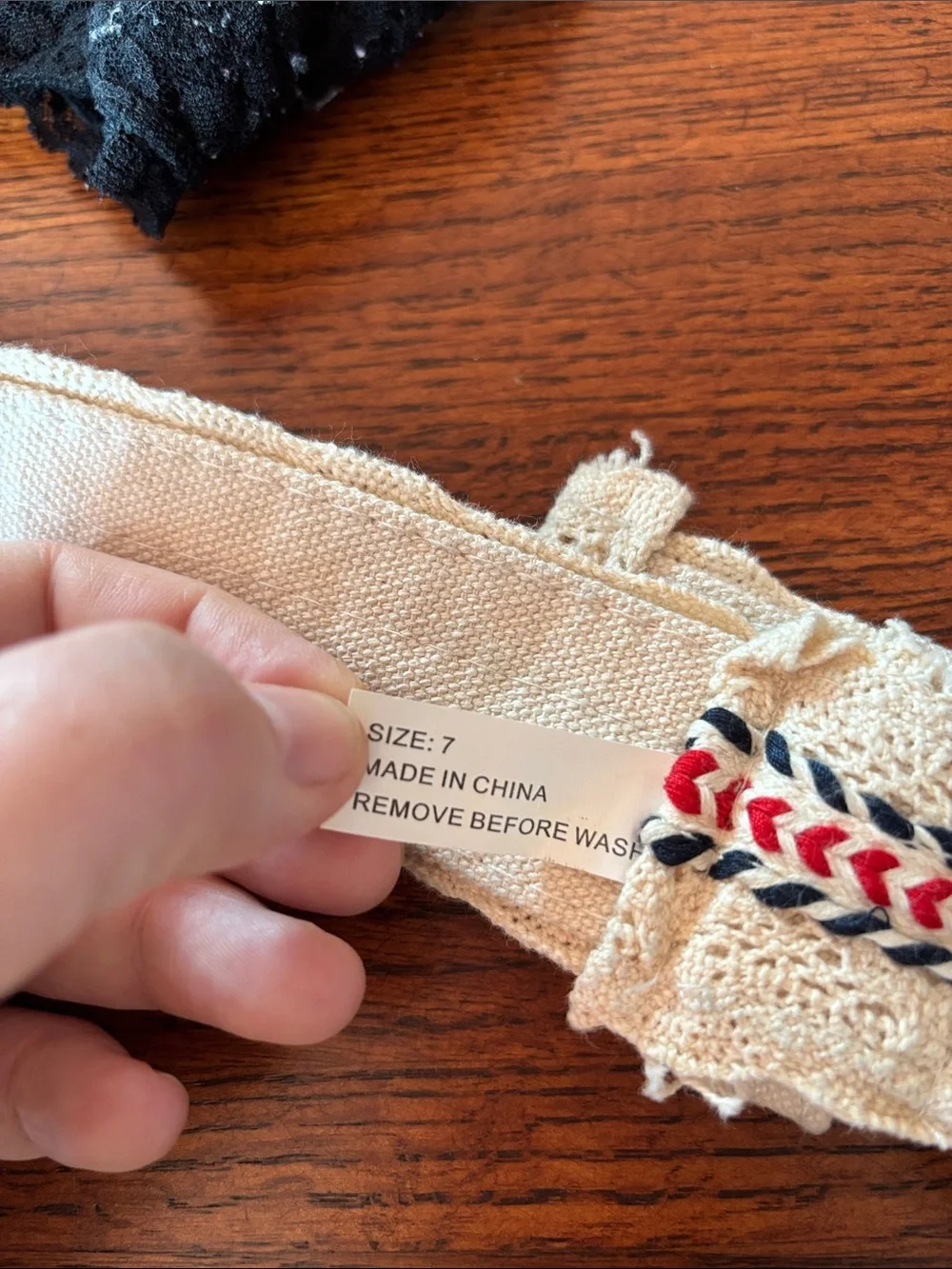 Canvas cream color crochet belt with red and blue embroidered accents. Size 7